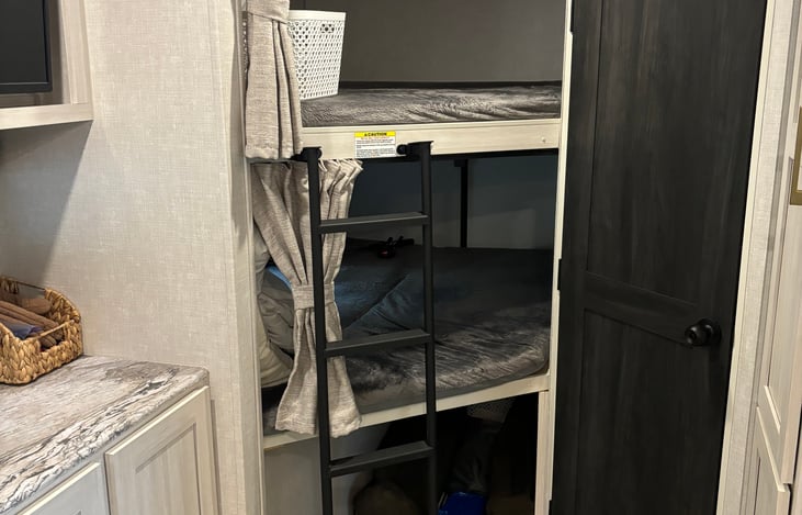 Rear Fullsize bunks with storage space, rear access door, USB plug ins and electrical plug ins in each.
