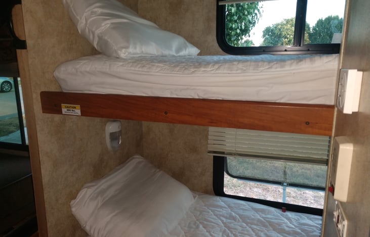 2 twin bunk beds with windows & lighting