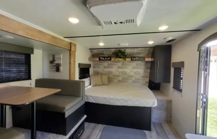 Dinette & queen bed plus storage and A/C (with full hookups or generator). We have a generator for rent as well if needed.