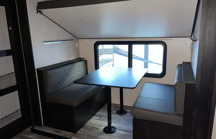 Bottom table can be lowered into a bed. Top bunk can be placed up out of the way too.
