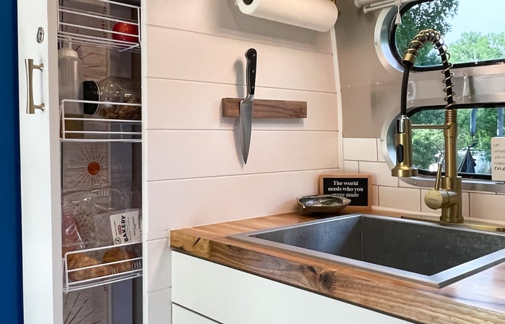 A convenient slide out pantry provides easy access ability and plenty of storage space.