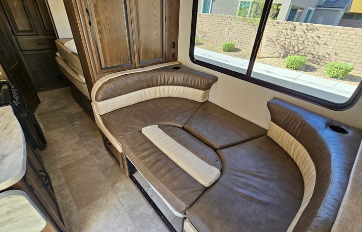 Showing dinette bed conversion and slid out in while in driving layout