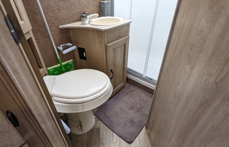 Full bathroom with toilet & shower.