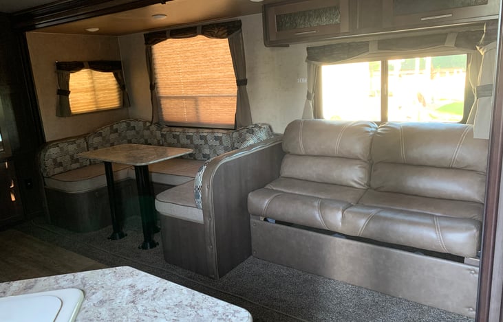 Eating area and couch both make into additional sleeping area