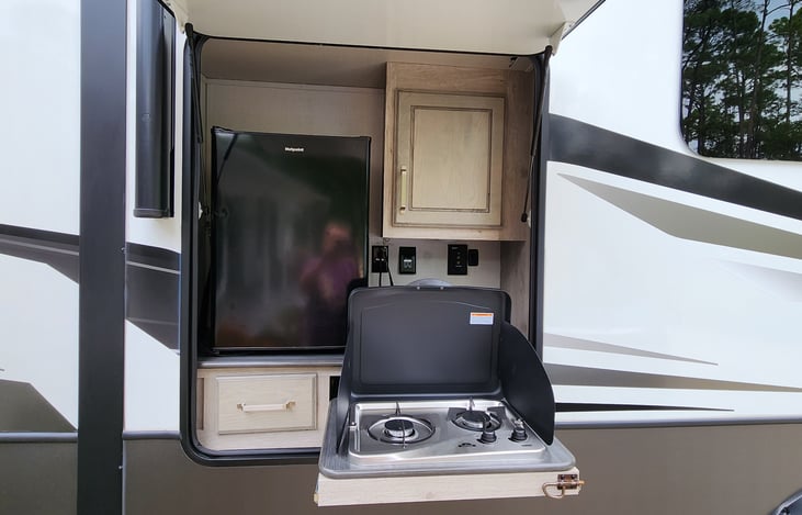 Outdoor kitchen with 2 burner stove and firdge