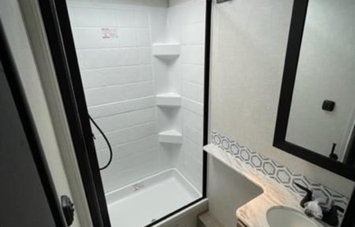 Bathroom - upgraded Porcelain Toilet, full shower with a retractable shower curtain.

Medicine cabinet behind the mirror

Hooks to hold towels