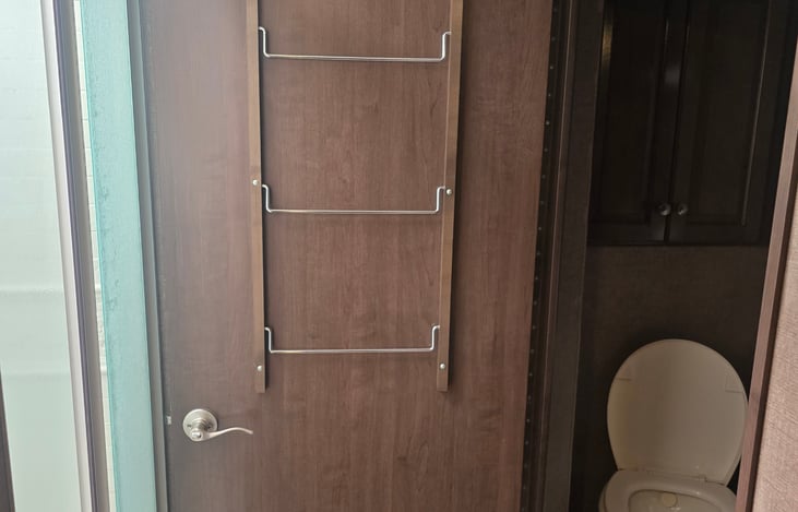 Bathroom door opens to create privacy divider for people taking a shower. This is a rare configuration and is absolutely invaluable for people who appreciate their privacy.