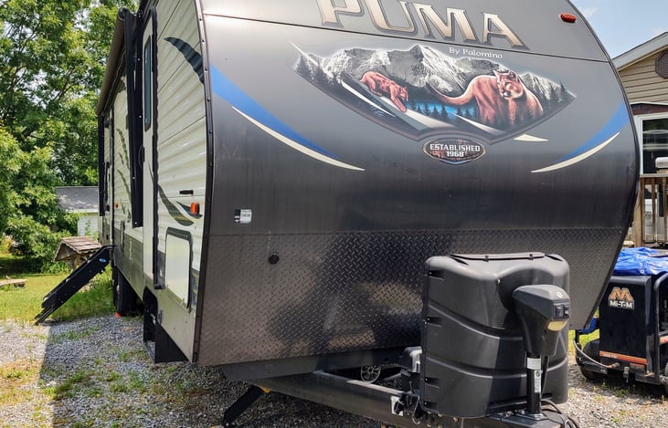 Two entrances and an outdoor kitchen on this side. The first entrance is to the master bedroom and the second entrance (shown with steps down) is to the main living area.