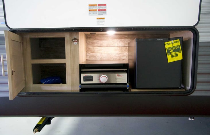 Outdoor kitchen,  flat top griddle,  mini-fridge and storage.