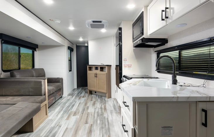 JayBird view from entrance door toward private bed room and bath.  Dinette folded down for bed.