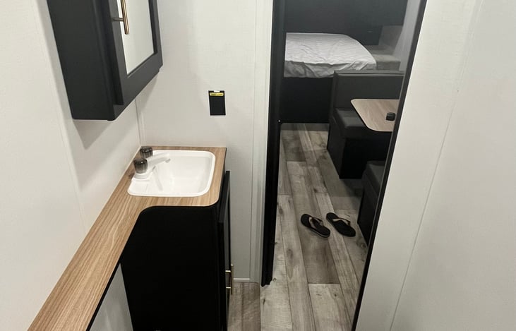 Bathroom includes bath linens, toilet paper, and fresh tank tablets.