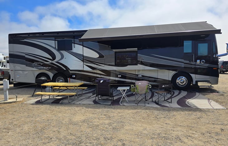 The bus has an awning for shade during outside entertainment or TV watching.  We also provide three rugs that span most of the length of the bus and three outdoor chairs.