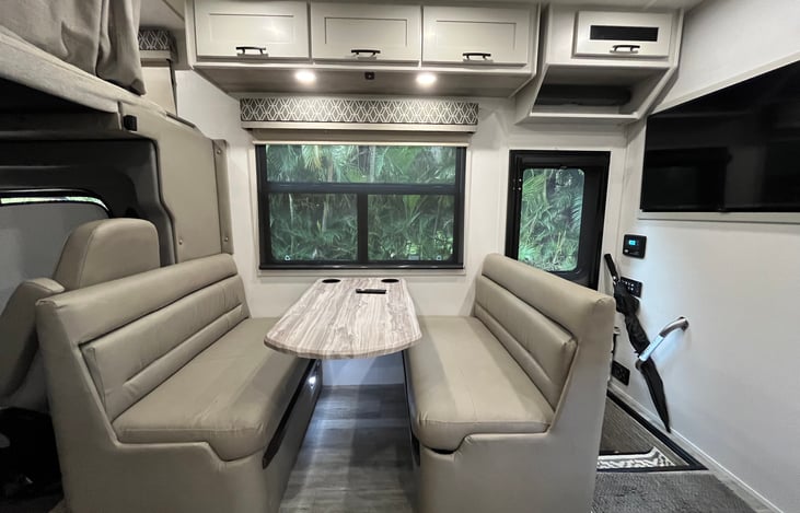 Dinette seats 4 and also folds down to a sleeper. Storage under both seats.