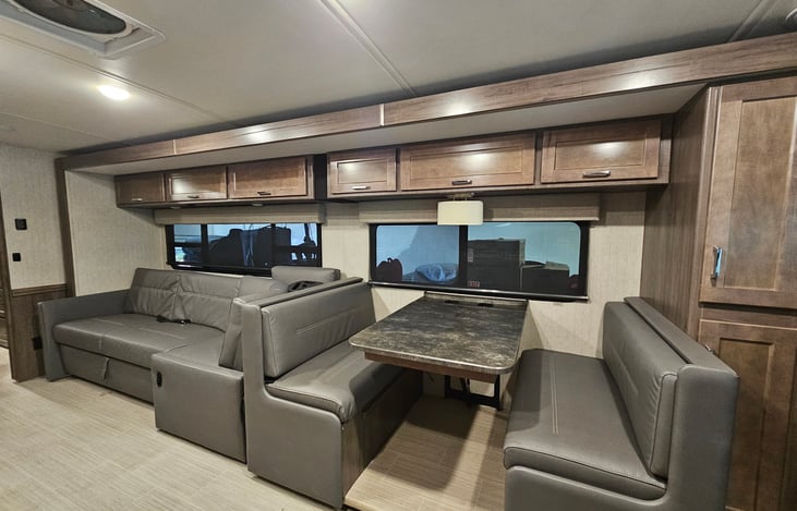 Dining area with 4 seatbelts, and sectional couch