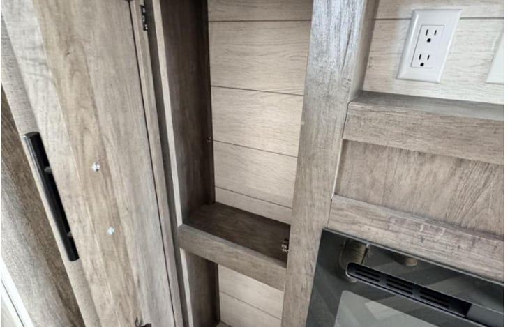 Additional storage next to fireplace on both sides.