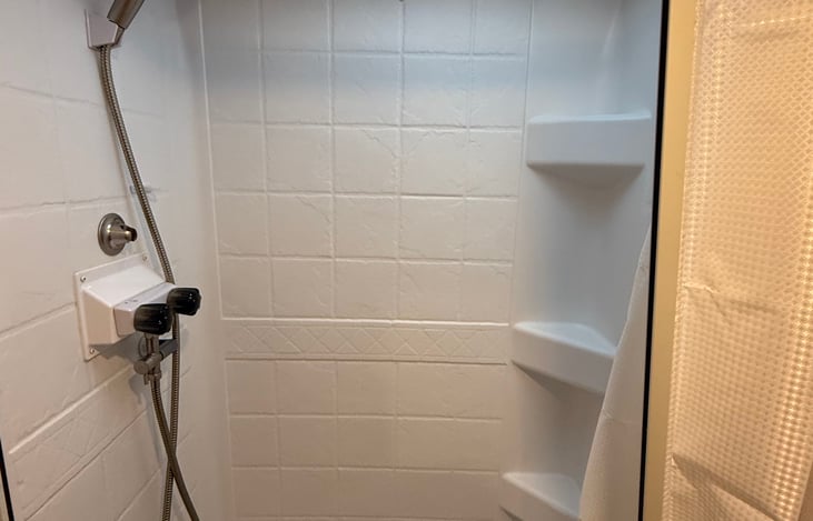 Shower has added head space for standing showers of 6' 3" people.