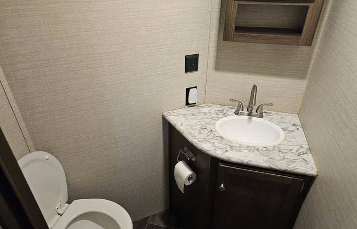 Second bathroom located in the rear bunkhouse, with sink and toilet.