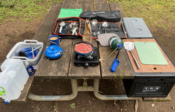 Preparing meals at the campground picnic table -- cooler and the camping box add extra surface area.