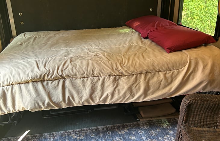 Rear queen  bed in rails, need more floor space raise the bed to the ceiling.  Just push a button.