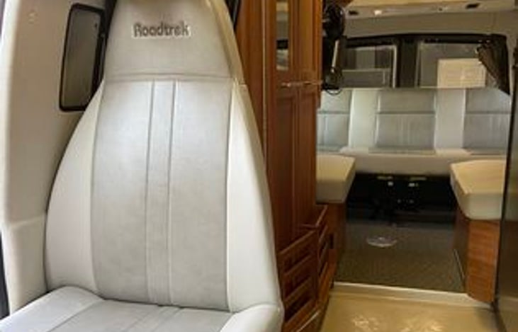 Third seat and bathroom behind it. Three available seats in the rear with only two seat belts. Total unit seatbelts five, but can accomaodate a total of 6 total.