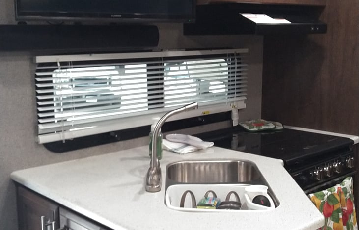 Window above stove for additional lighting.