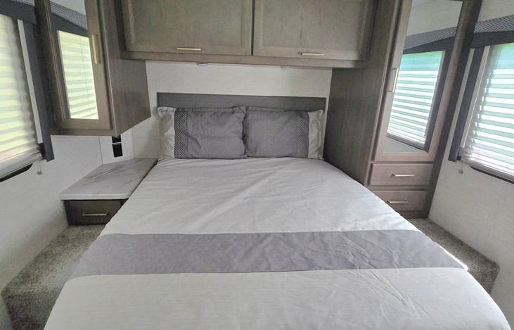 The Master Bedroom! Cabinets, Lighting, and Queen sized bed.