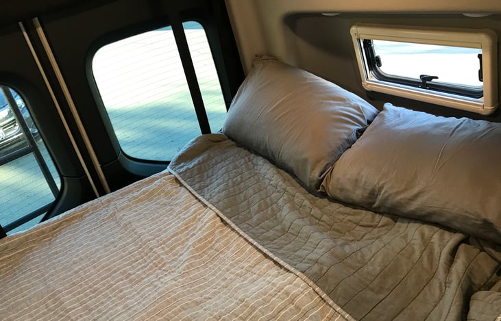 Full size bed with included bedding. The van heater does an awesome job of keeping you warm for those winter cold nights.