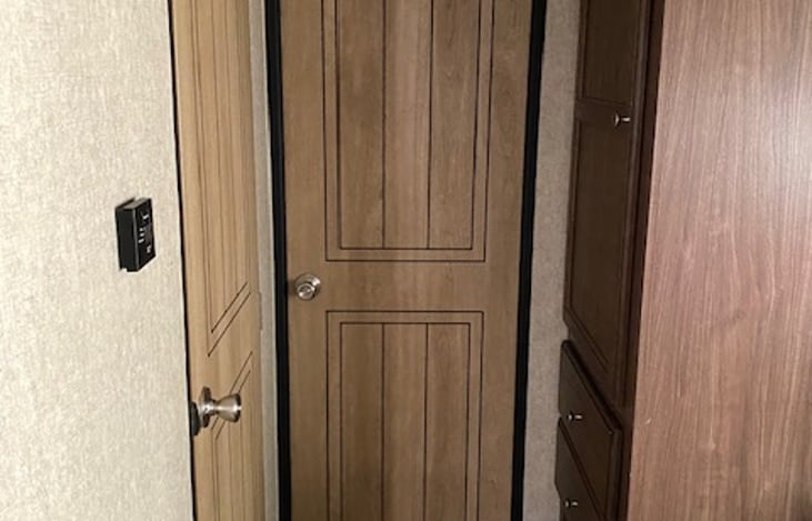 Closed door to the bunkhouse (bathroom to the left)