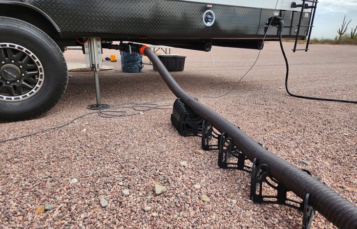 30/50 AMP power connection and the second grey water tank connection with hose support.