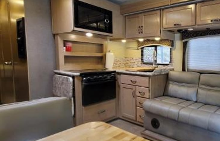 stove top, oven, sink and microwave with counter extension