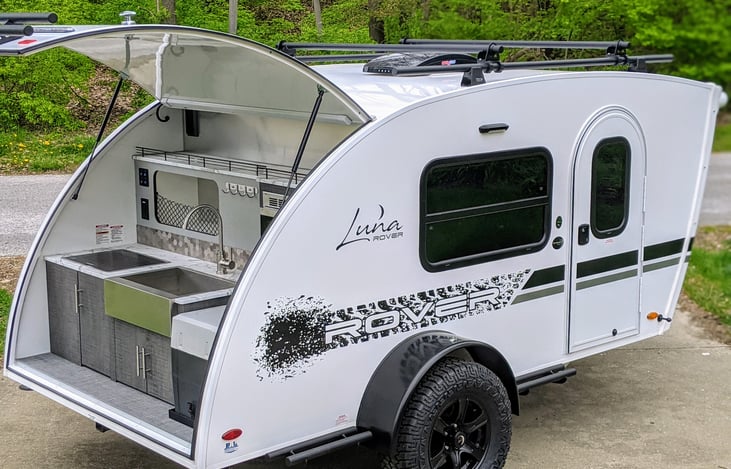 The outdoor kitchen on the Luna Rover is just the right height for cooking and cleanup. Kitchen storage space is amazing in this compact teardrop camper trailer.