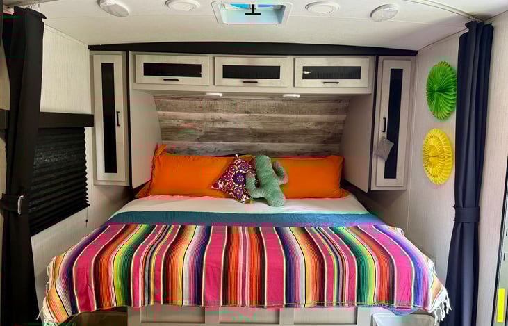 King size bed with luxurious linens. His and her closets and overhead storage.