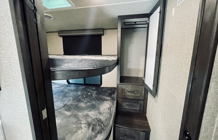 Full sized bunks with dresser drawers and closet.