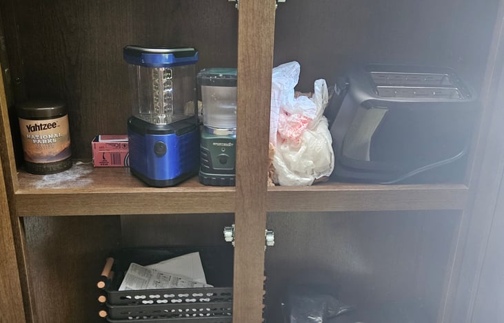 Lanterns and toaster in cabinets under TV