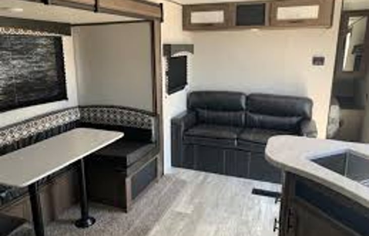 Small couch folds down to sleep one, maybe two. There is plenty of space in the floor for a blow up mattress if needed. There is also storage under the dinette and the couch!