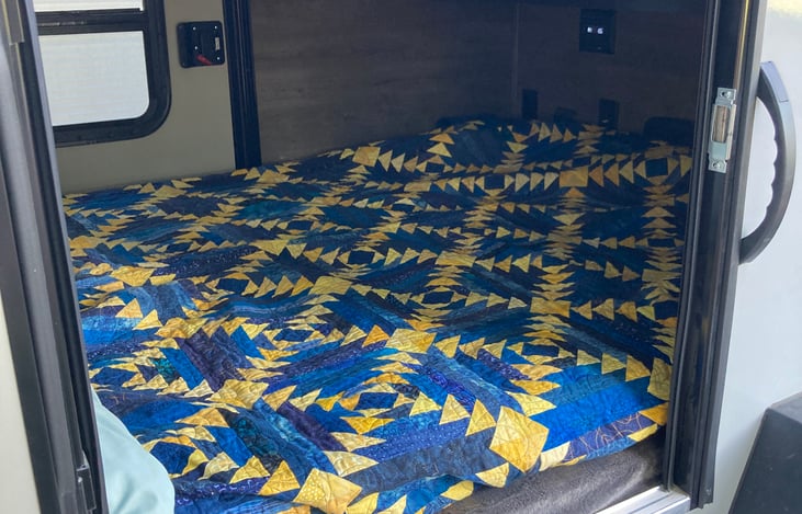 Full-size bed in the camper.