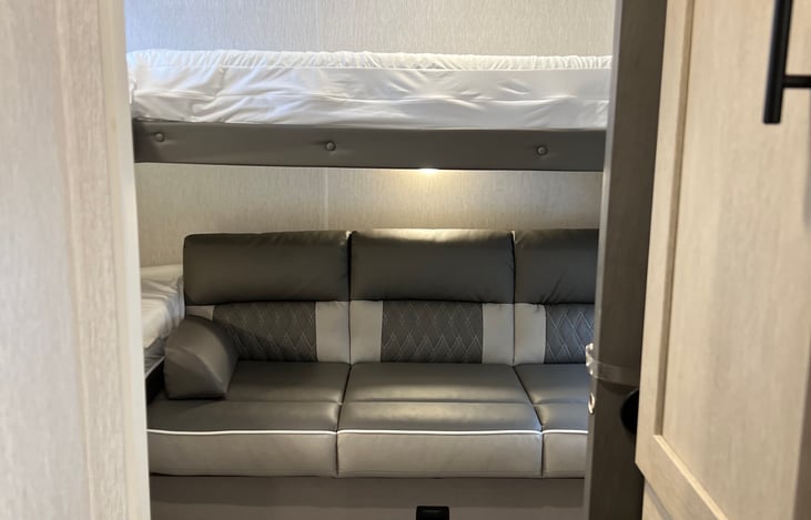 Bunk house room! Includes 3 bunks and 1 couch (folds out into a full). All 3 bunks have an upgraded 3" memory foam mattress