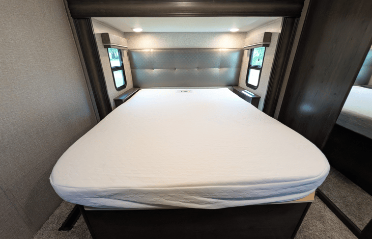 Private master suite with a queen bed, residential mattress, reading lights, deep dresser drawers, massive front wardrobe with hanging space, and washer/dryer prep. High-end restful comfort!