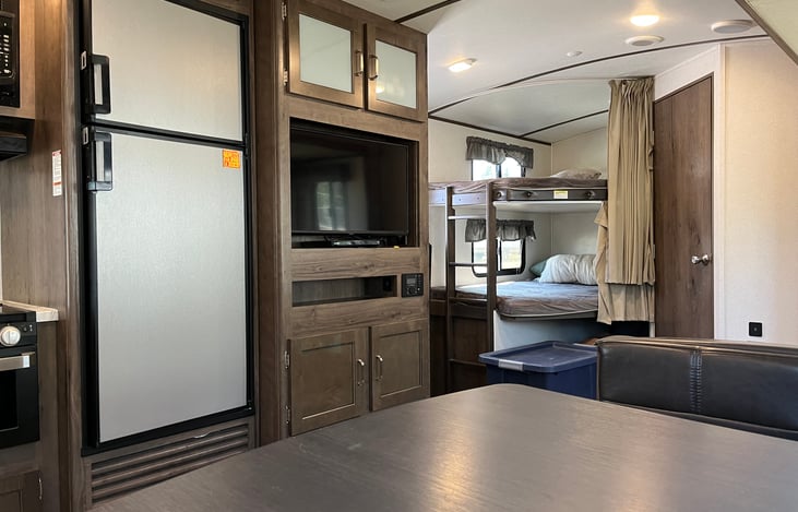 Full size refrigerator and freezer inside (beverage fridge on side of camper).  Mircrowave, gas stove, toaster, coffee maker, hot water maker.  All silverware available as well.