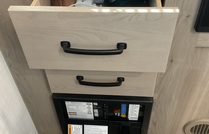 storage drawers, with flash light, charging cables. Camper manual, Bluetooth speaker, etc.

Below - camper fuse box