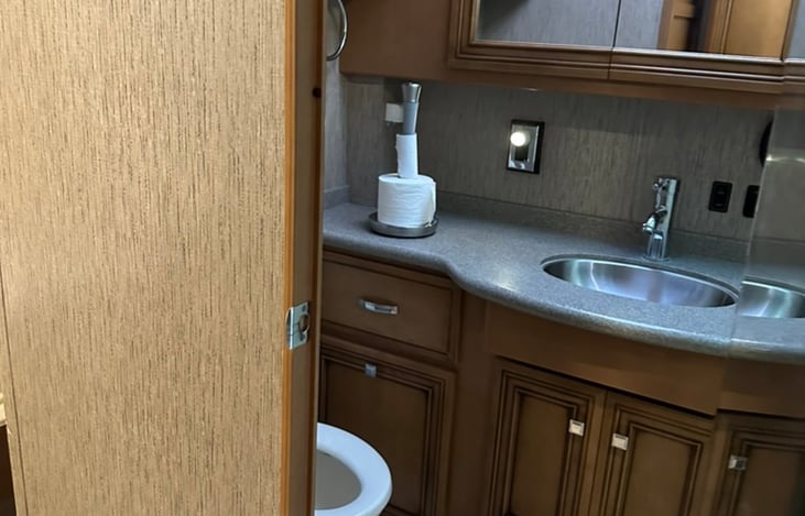 Bathroom vanity with mirror lighting and storage