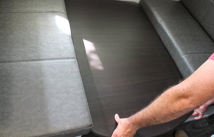 Step 2: place the table top on the black stabilizers you will see them under the cushions in the edges.