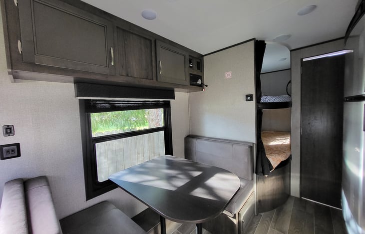 Table and bench seats turn into a bed. Lots of storage above head and in bench seats!