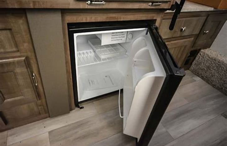 Refrigerator works on propane or electric wile the trailer is being towed and once you set up.