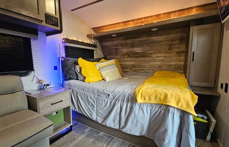 Super cozy and comfy bed with a night stand for your electronics.