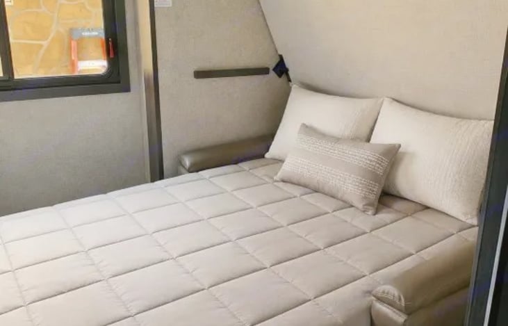"Blue Grass Beauty" includes a 39" x 74" bunk over a wardrobe and a second 30" x 74" bunk above a versatile tri-fold sofa.  Perfect for kids or even a second family.