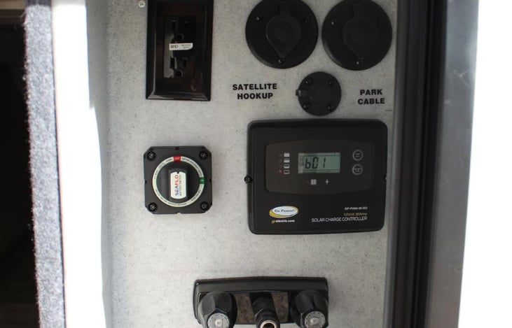 Out side shower, solar panel dash and main power switch.