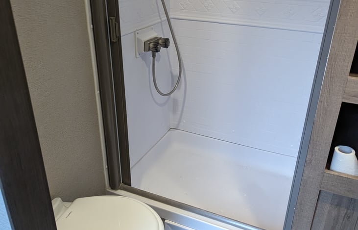 Bathroom with a nice-sized shower with upgraded shower head.