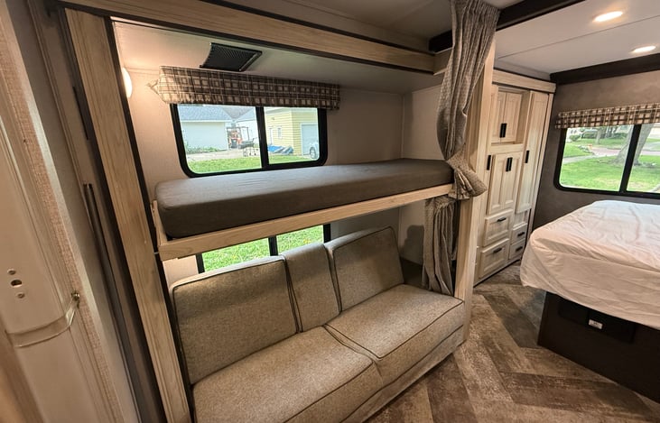 Top bunk we use to hold our luggage. We do not recommend anyone being up on this bunk during travel.