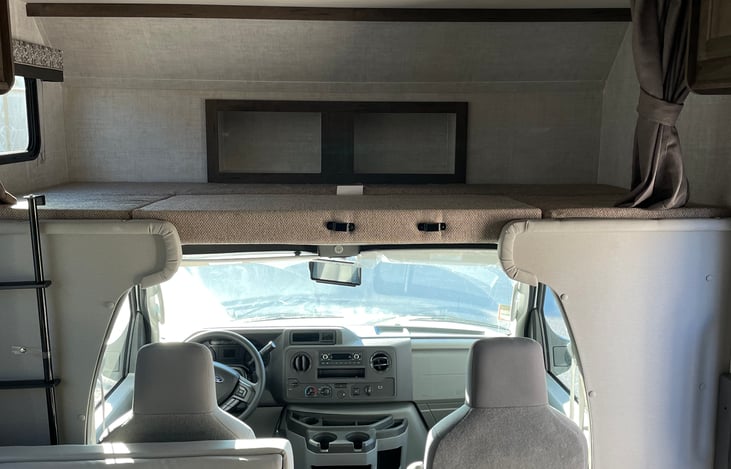 Above cab sleeping quarters with ladder.